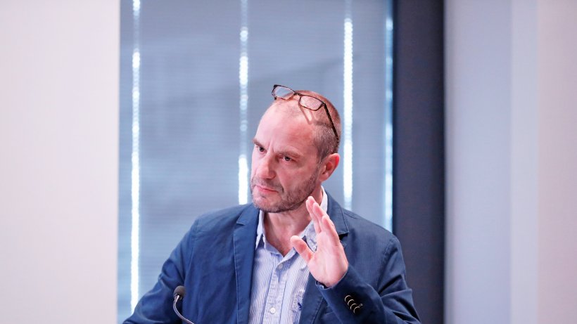 R. Kollmorgen speaks into a microphone