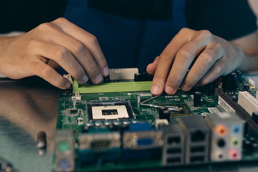 Hands over a circuit board