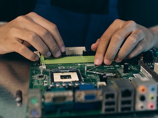 Hands over a circuit board