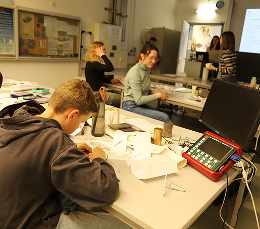 Pupils tinker with paper airplanes in the materials lab.
