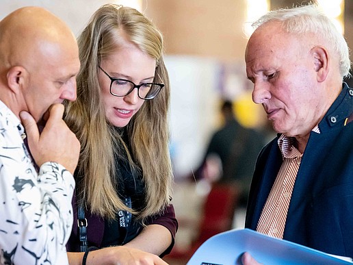 Visitors look at a brochure.