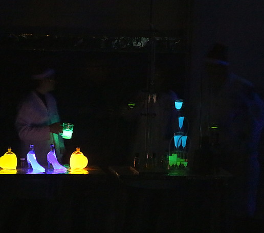 In the dark, glass jars glow in neon colors.