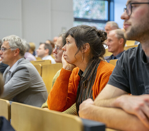 The rows of seats are filled with people looking ahead.