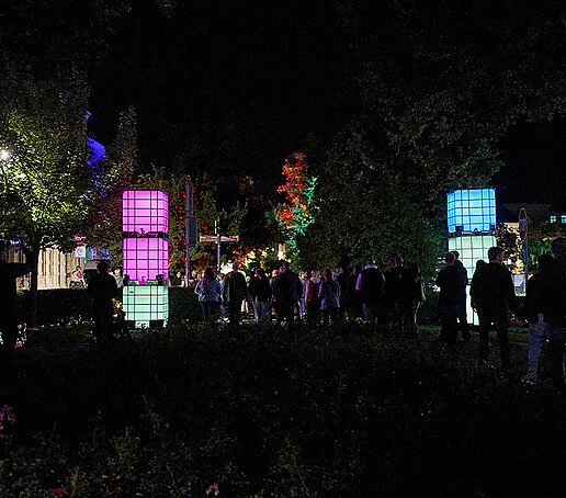 Glowing cubes are stacked on top of each other on the ring road.