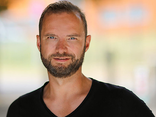 Lars Rönisch smiles into the camera.
