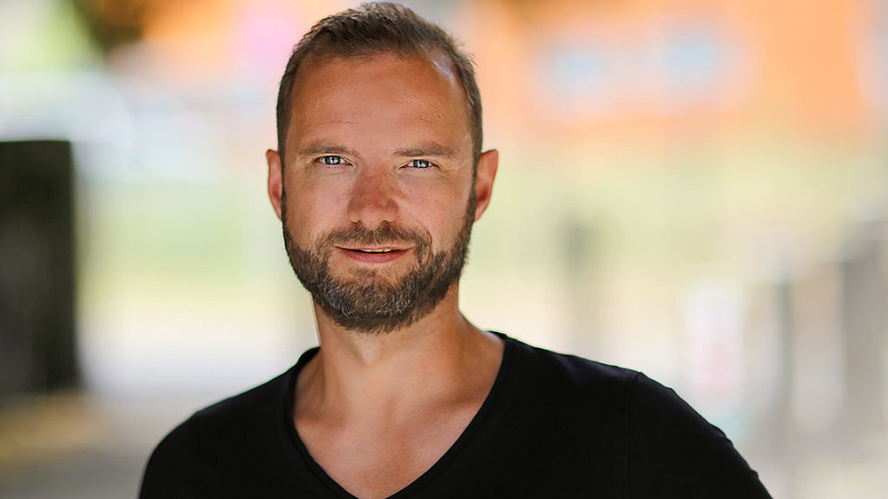 Lars Rönisch smiles into the camera.