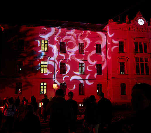 A building illuminated in red.
