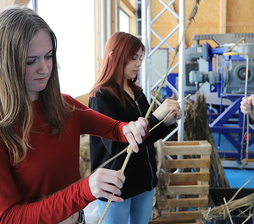 Girls bend straws at the Natural Fiber Center.