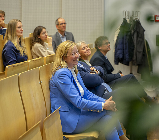 The rows of seats are filled with people looking ahead.