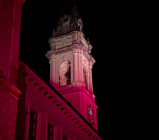 The Johanneum tower is illuminated in red.