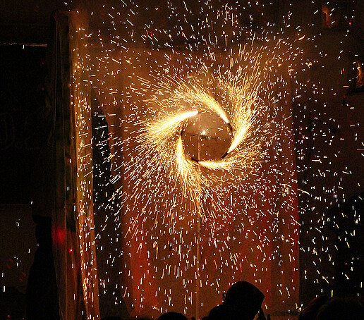 A firework spinning top rotates on the stage.