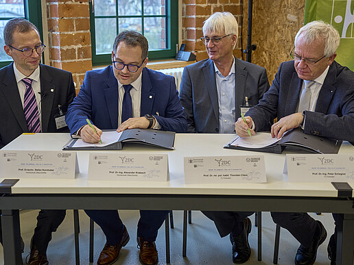 Four people sign a declaration