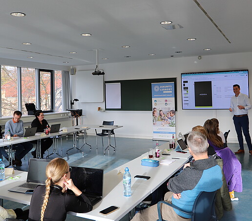 Workshop participants listen to a lecture in a seminar room.