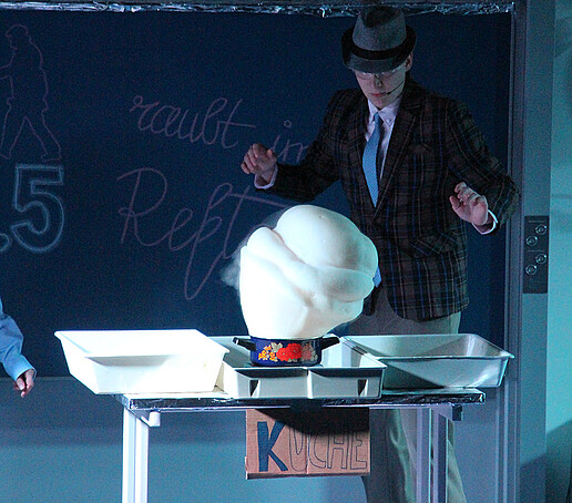 A performer observes a foam fountain.