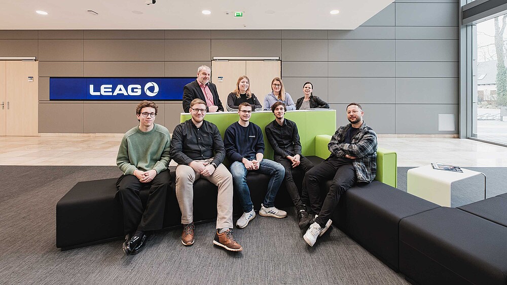 LEAG and university representatives sit on the sofa in the LEAG foyer.