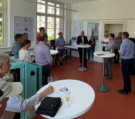 People stand in the lab and celebrate the opening.