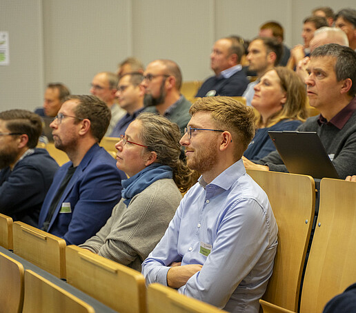 The rows of seats are filled with people looking ahead.