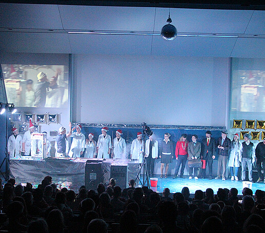 The performers stand next to each other as a group at the degree.