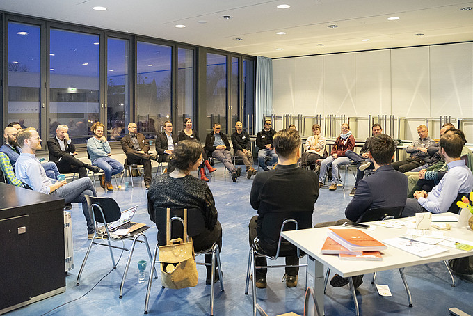 Filled circle of chairs in the seminar room