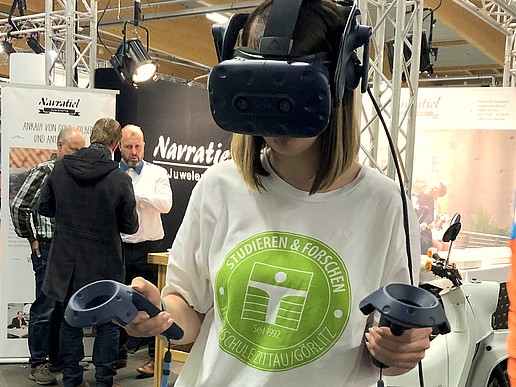 Melanie Weickelt, Public Relations employee, tries out the VR glasses for the first time