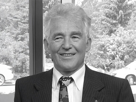 Prof. Hedrich in a suit smiles into the camera.