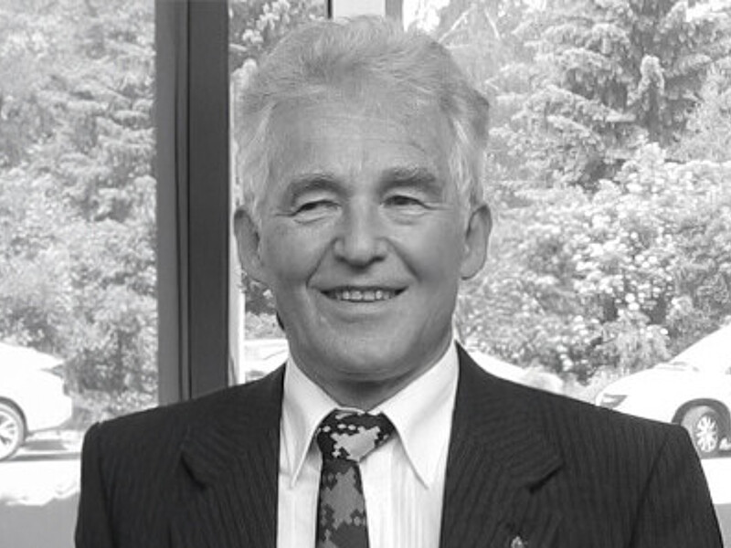 Prof. Hedrich in a suit smiles into the camera.