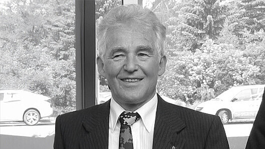 Prof. Hedrich in a suit smiles into the camera.