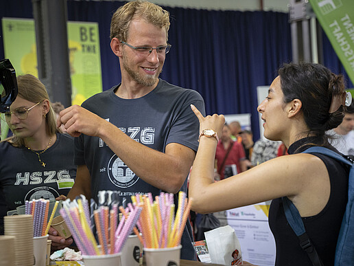 University staff in conversation with interested parties