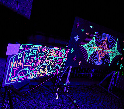Fluorescent colors illuminate a canvas in neon colors.