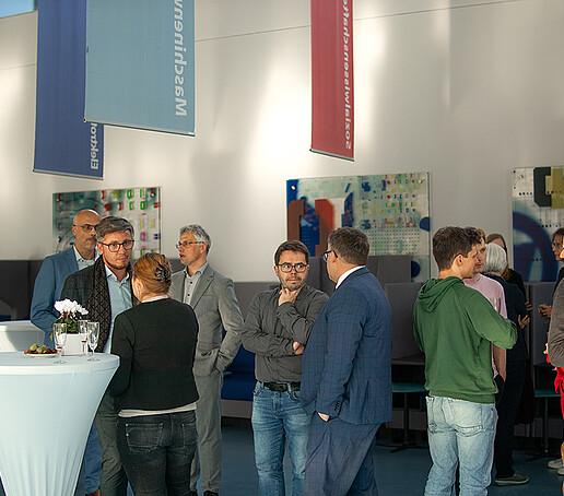 Guests at the event are engrossed in conversation.