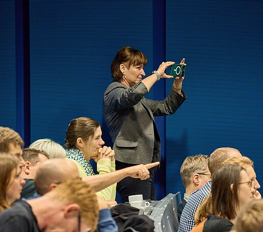 A person takes photos in the lecture hall