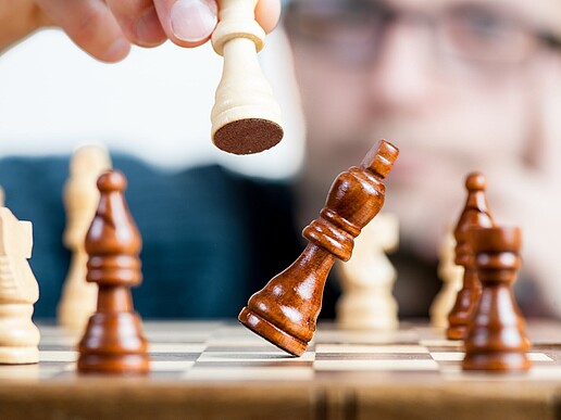 Person holds chess figure