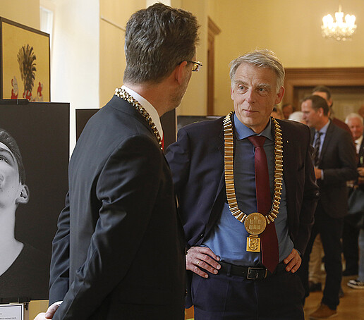 Guests chat in the foyer next to the council chamber.