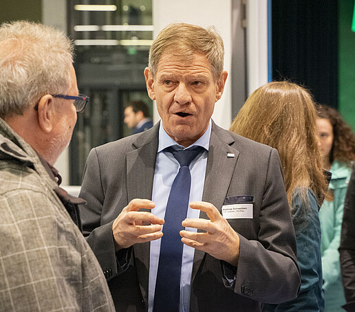 Matthias Schwarzbach in conversation with guests during the event.