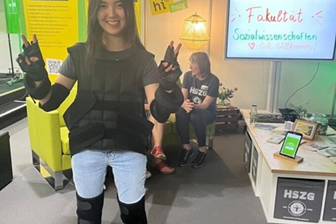 A visitor tries out aging techniques on her legs and arms.