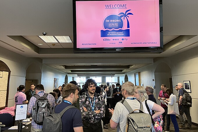 Welcome Reception of the Network and Operations Management Symposium 2023 in a conference hall