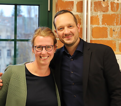 Two workshop participants smile at the camera.