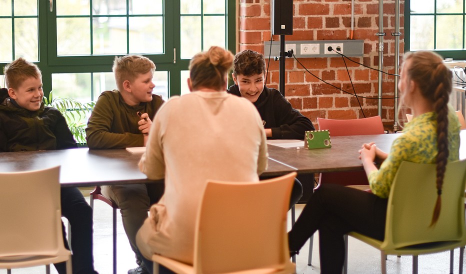 Foto: Saxony5 Das Organisationsteam des Wissenschaftskino auf dem Dorf sitzt im Celsiuz an einem Tisch und berät sich.