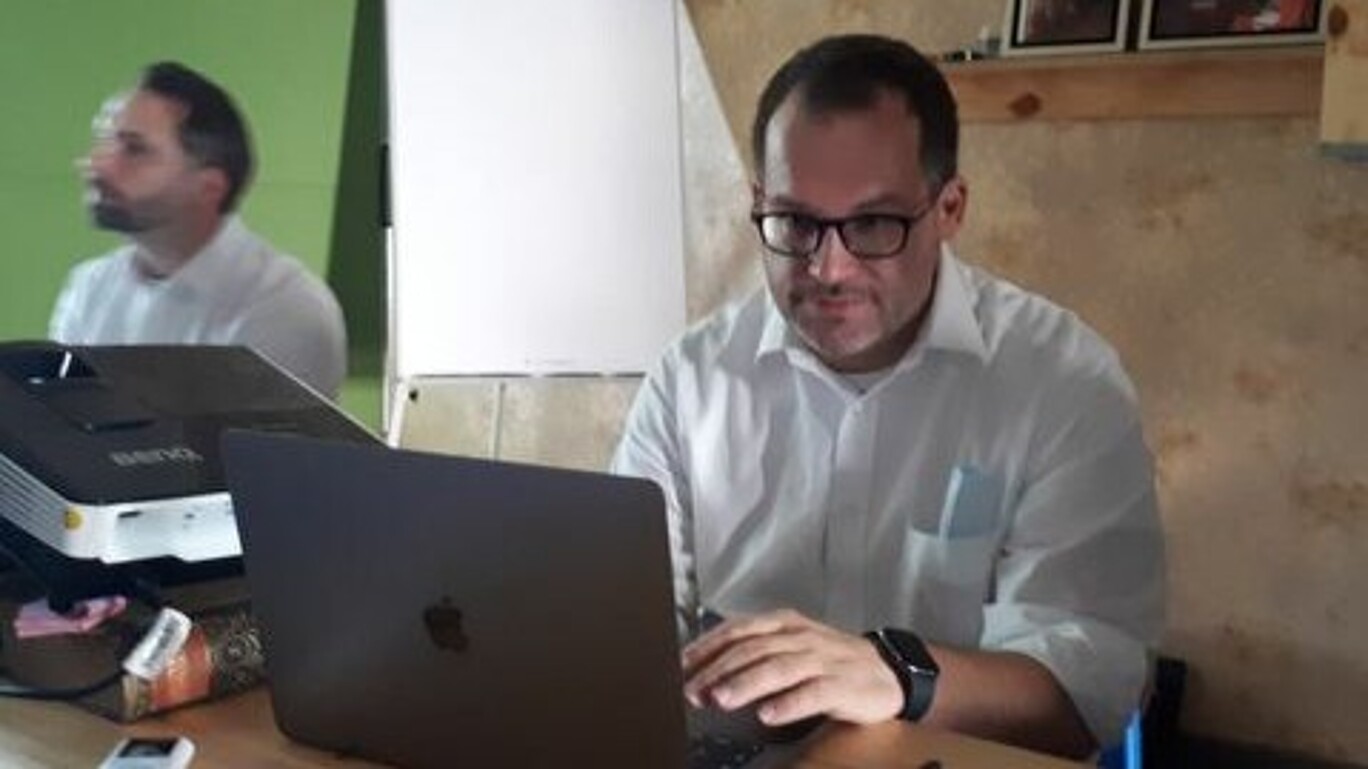 The Rector of the HSZG sits at his laptop and works.