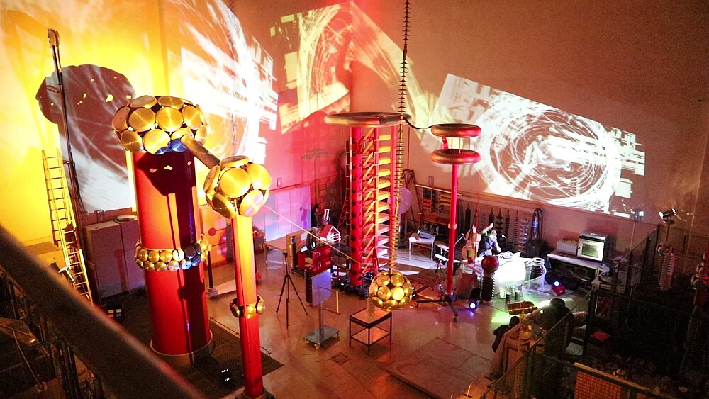 Musicians in the illuminated high-voltage hall
