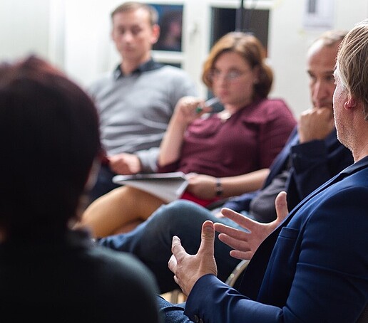 A group of storytellers sit together and tell stories.