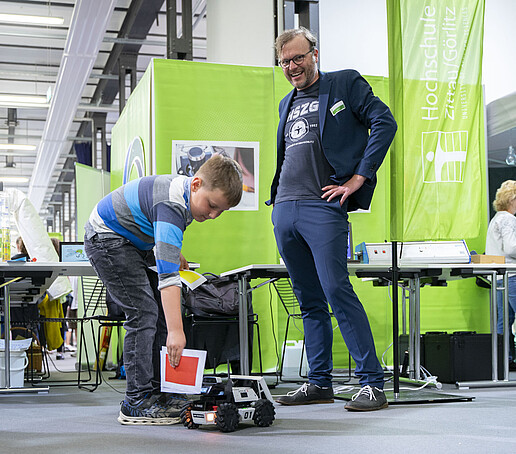 A child tries out a robot.