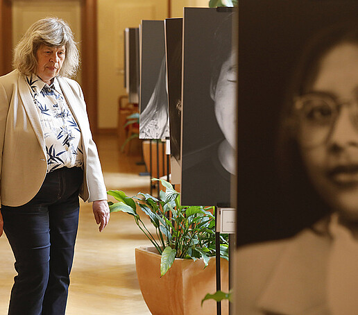 A visitor looks at the photo exhibition in the foyer of the town hall.