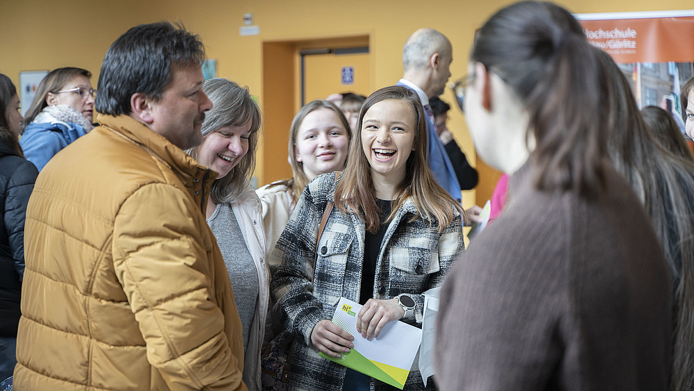 A group of prospective students in the foyer of G I