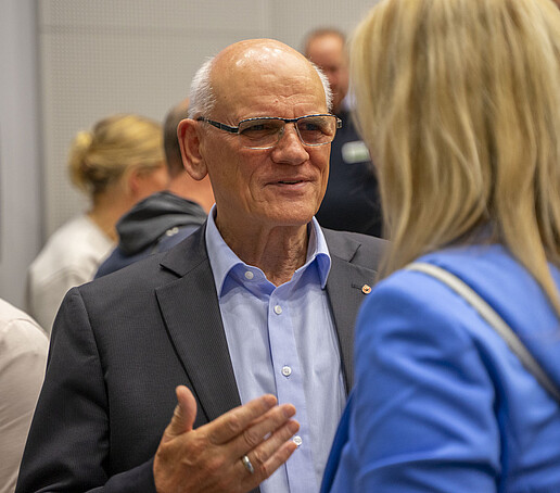 An older gentleman is talking to the Vice President.