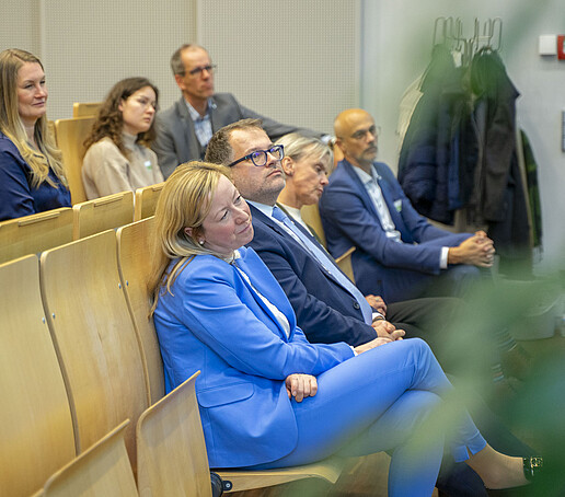 The rows of seats are filled with people looking ahead.