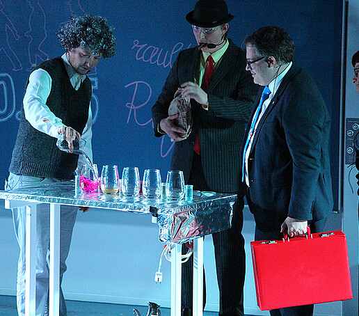 The Olsen Gang conduct an experiment with colorful liquids.