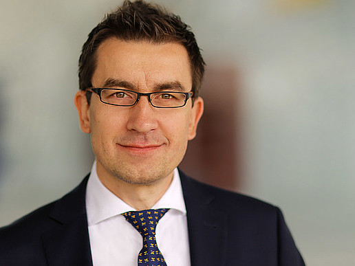 Professor Dzienis smiles into the camera.