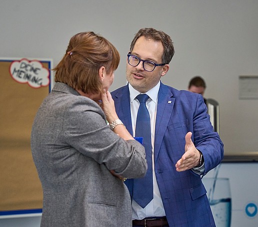 Two people (principal and employee) in conversation.