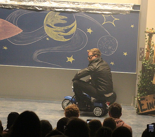 The Terminator on a scooter on stage.